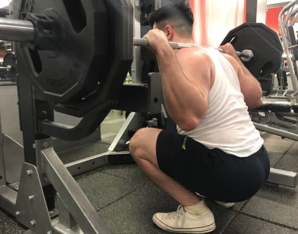 Squatting in Jed North Fitted Lifting Shorts - Rear Oblique View - Bottom of Squat Rep - 4