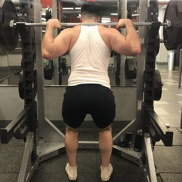 Squatting in Jed North Fitted Lifting Shorts - Rear View - Unracking Bar