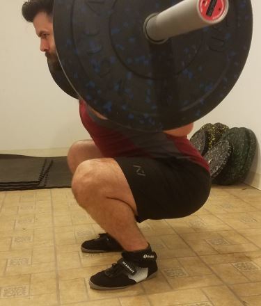 Squatting in A7 Center-stretch Shorts - Side View - Bottom of Squat Rep