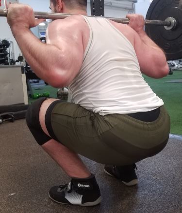 Squatting in Young LA Lifting Shorts - Rear Angled View