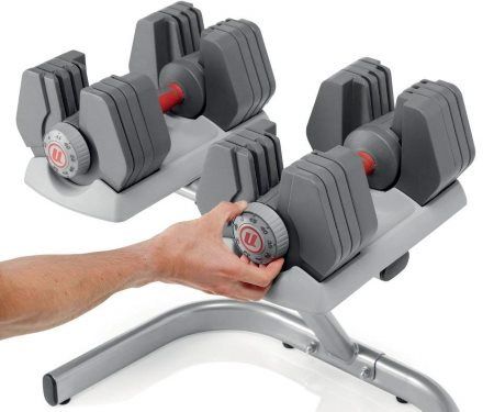 Universal 445 Selectorized Adjustable Dumbbell Set - Man Adjusting Weight Dial
