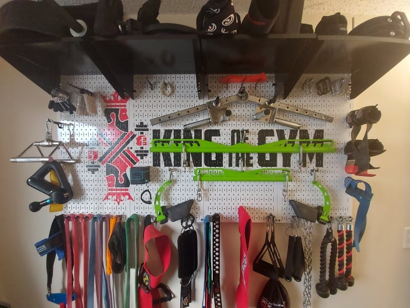 Wall Control metal pegboard storage system for cable attachments and gym accessories