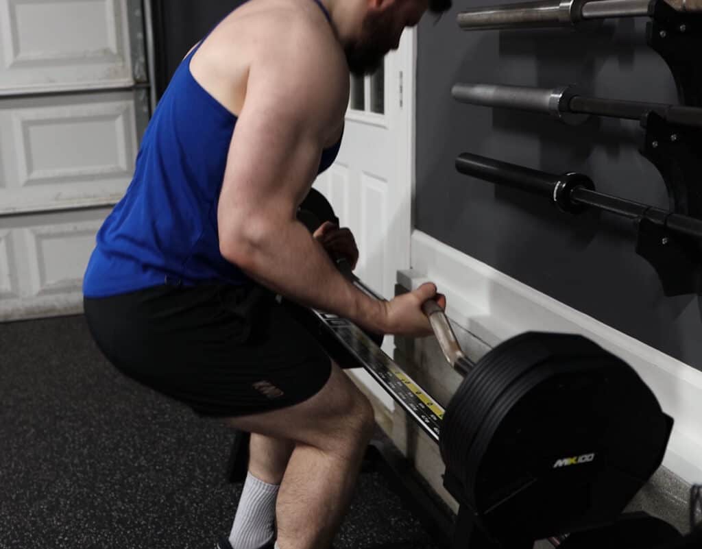 Crouching Down to Unrack the MX Select MX100 for Curls